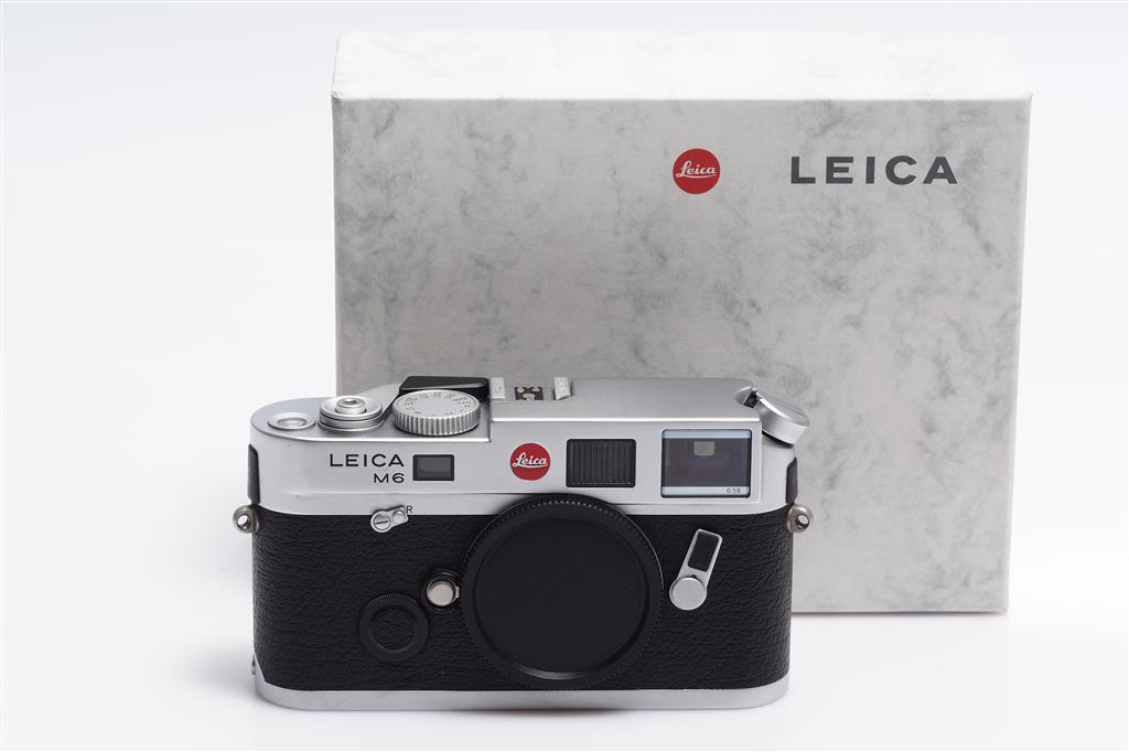 Chrome Leica M6 TTL camera in front of the original makers box