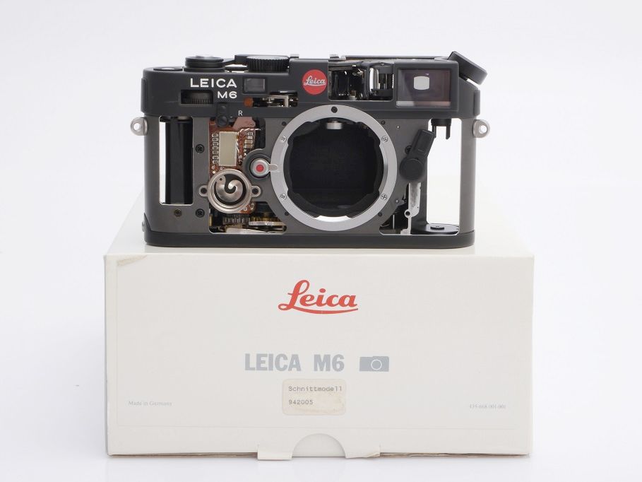 Black Leica M6 cut-away model standing on the makers box